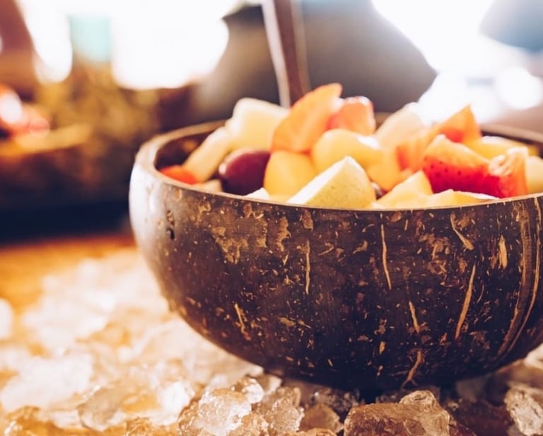 a fruit salad in a coconut bowl