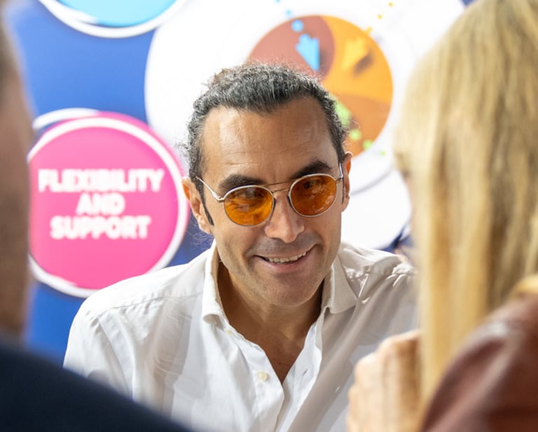 Matteo Borea smiling with customers during a coffee exhibition