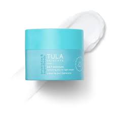 Tula Skincare 24-7 Moisture Hydrating Day and Night Cream in a blue jar with a white lotion smear.