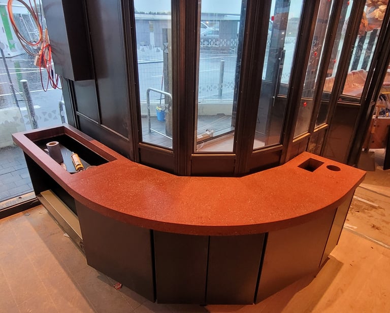 Comercial polished concrete round, red countertop