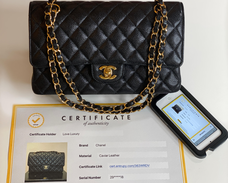a black Chanel handbag with original documentation and certificate of authenticity