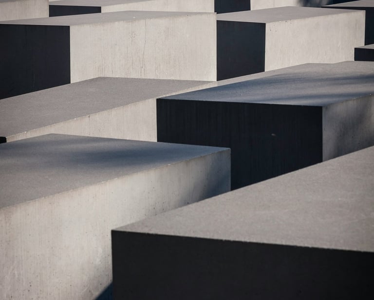 Array of varied concrete blocks with strong shadows.