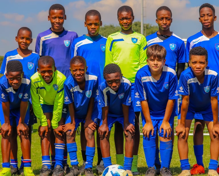 a group of young boys are posing for a picture