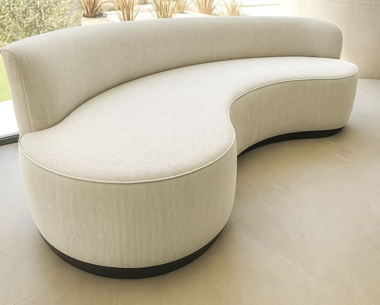 Curved light-gray upholstered sofa with textured fabric and black base in modern room with natural light — by Solo Home Decor
