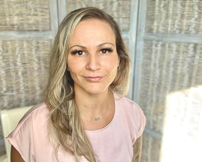 a woman with blonde hair and a pink shirt