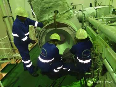Our technicians are doing the turbocharger maintenance in a ship engine room.