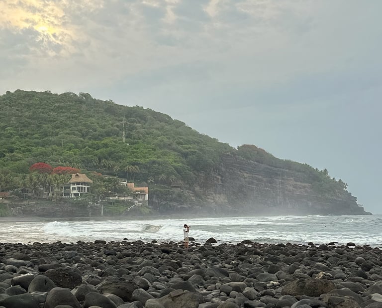 camera man taking pictures at rocky beach