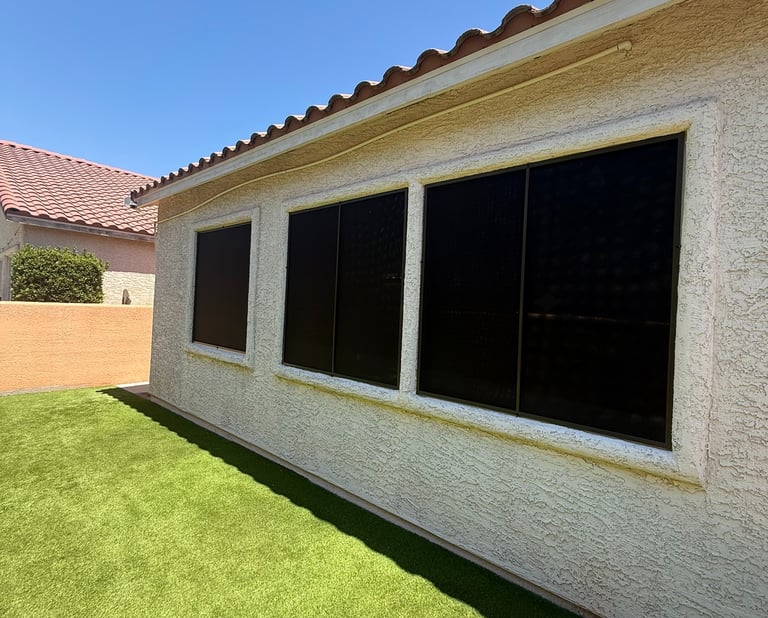 Windows with black solar screens and bronze frames