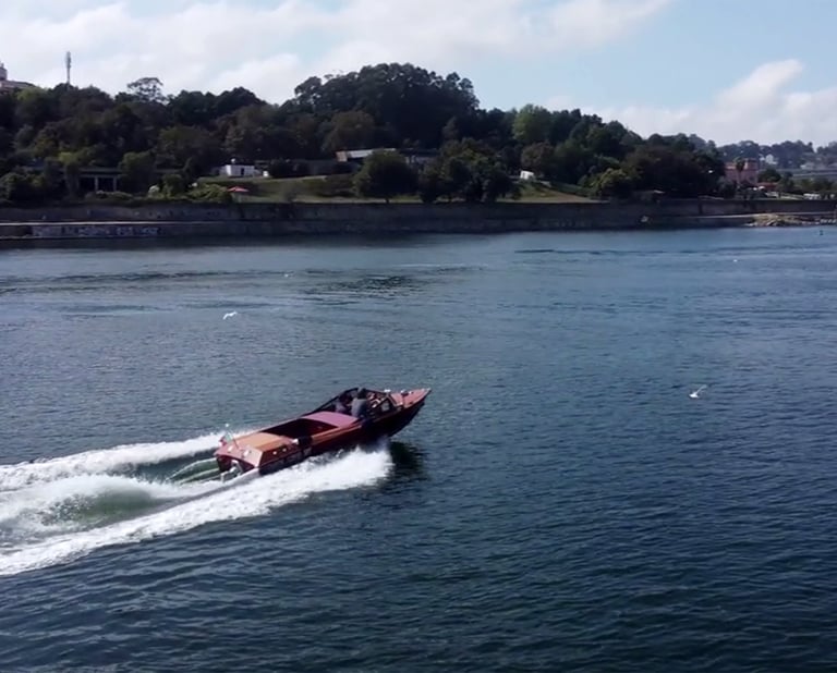 Guests enjoying a James Bond–style ride on Eskrok, a classic speedboat on the Douro River