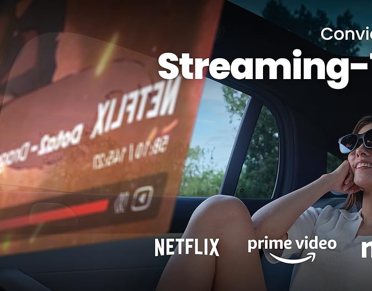 a woman sitting in a car watching tv