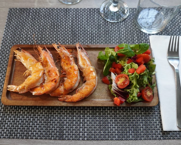 a table with food with a wood plate and salat