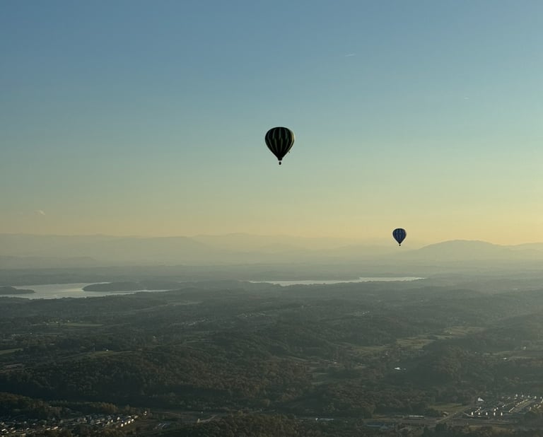 a hot air balloon in the sky with a view of the city