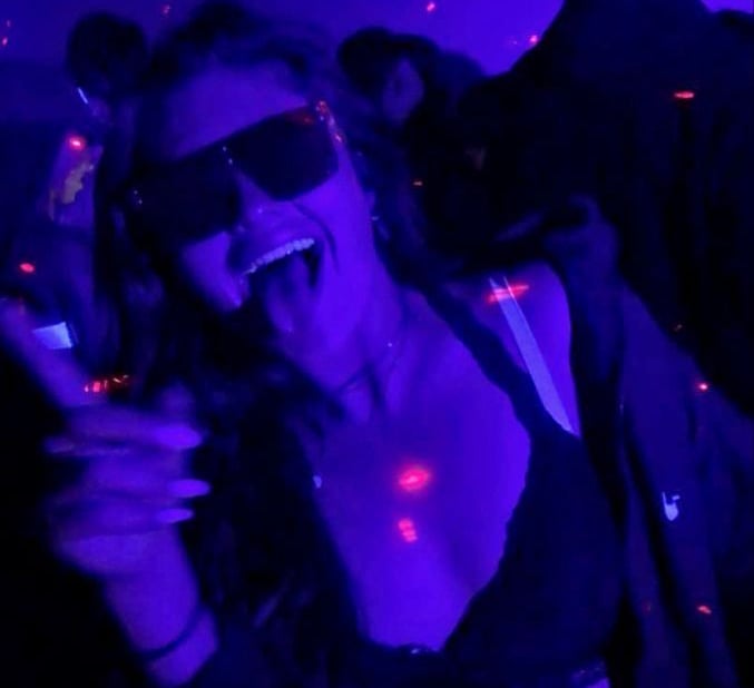 a woman in a black bra top and sunglasses during the Riga Pub Crawl
