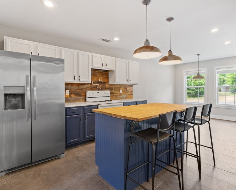 a kitchen with a wooden table and chairs
