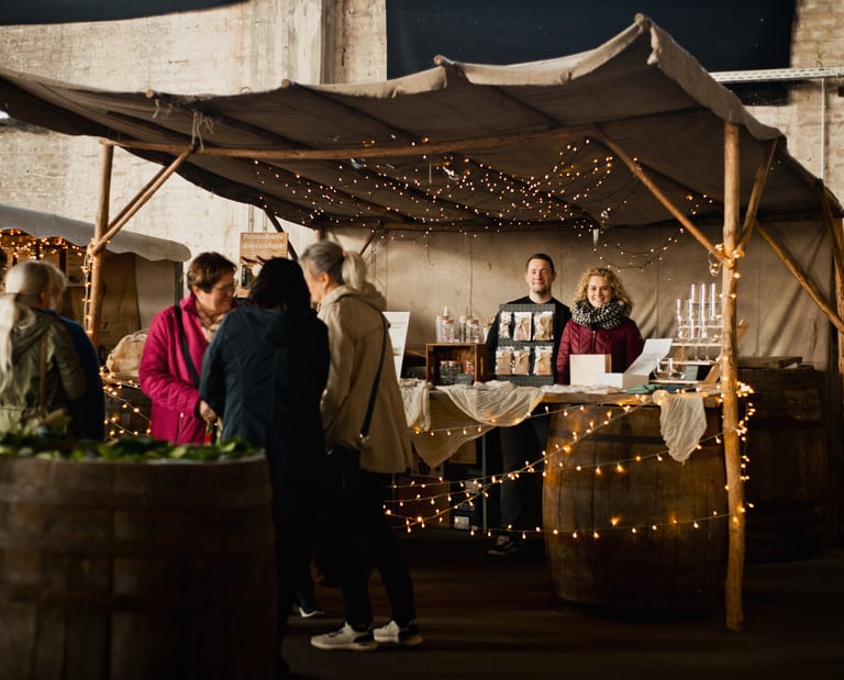 a group of people standing around a table with wine glasses
