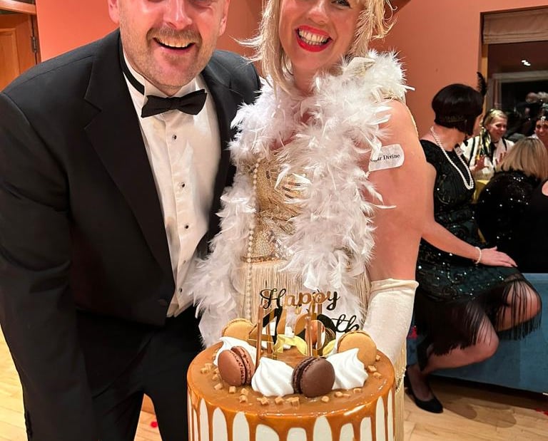 man and woman smiling at murder mystery birthday party