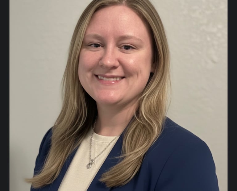 a woman in a blue jacket and white shirt