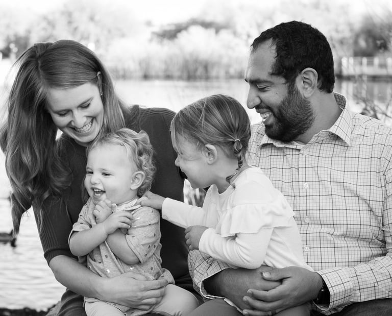 Parents laughing with their young children during an outdoor family photography session in Arizona.