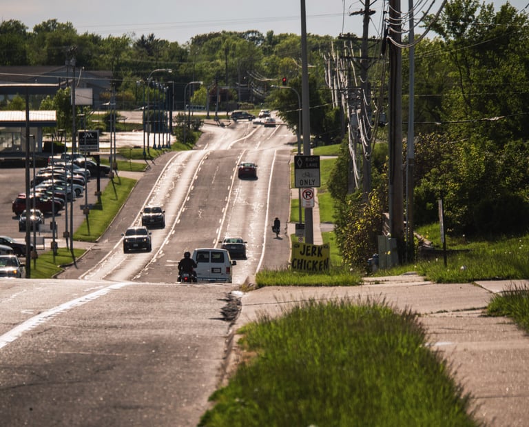 Cars on a busy road, and you can see fumes on the street