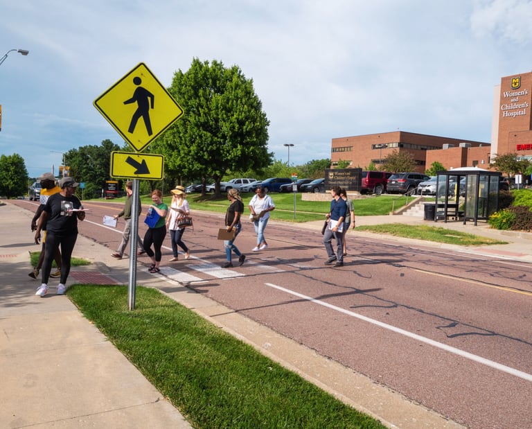 Group of people walking across a crosswalk