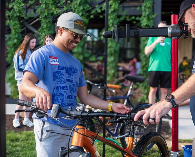 Person smiling handling a bike after cleaning it!