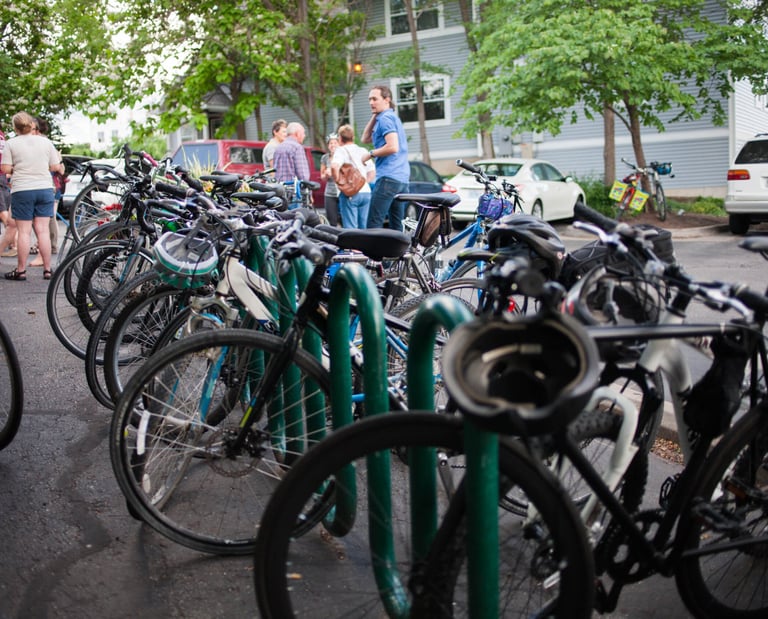 A full row of bikes on a long bike rack