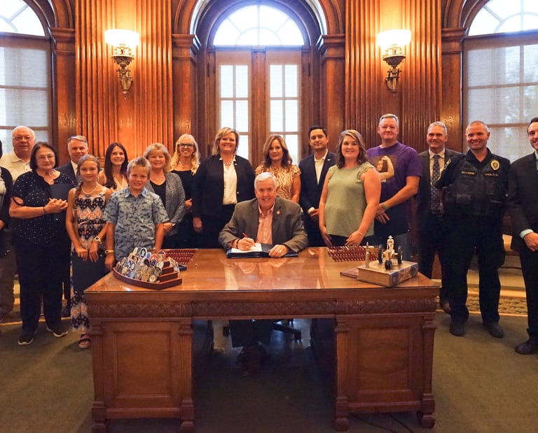 Large group of people in the governor's office, posing for a picture