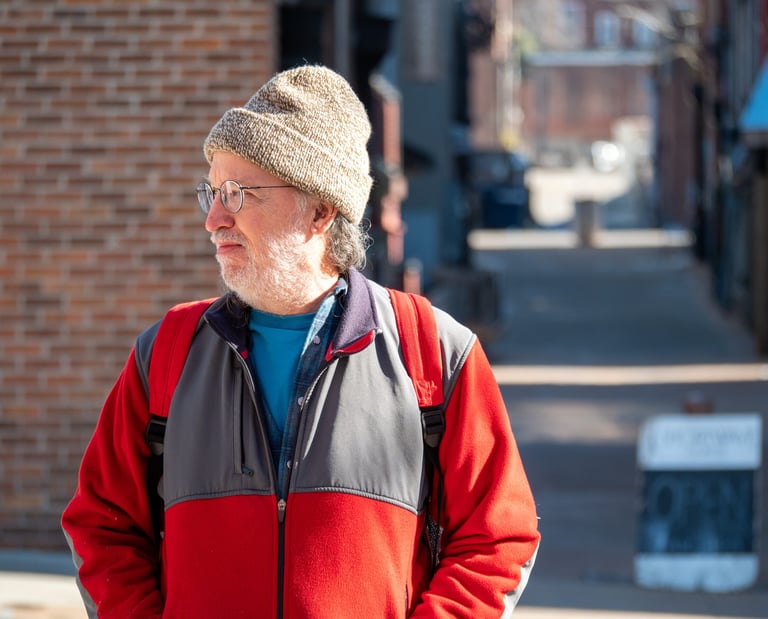 Headshot of Jack Gardiner in a city looking to the side