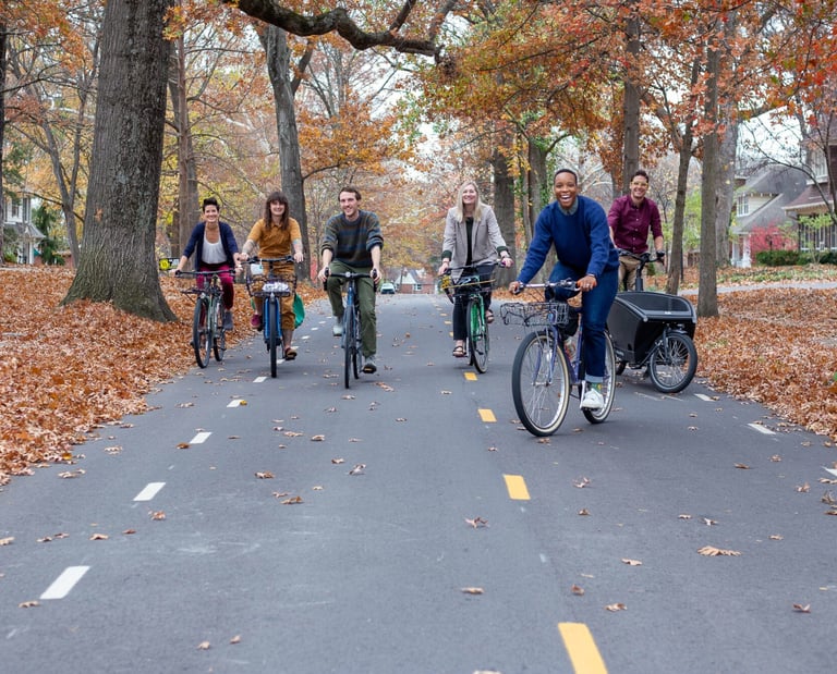 A bunch of people on bikes riding toward the camera on a bike boulevard