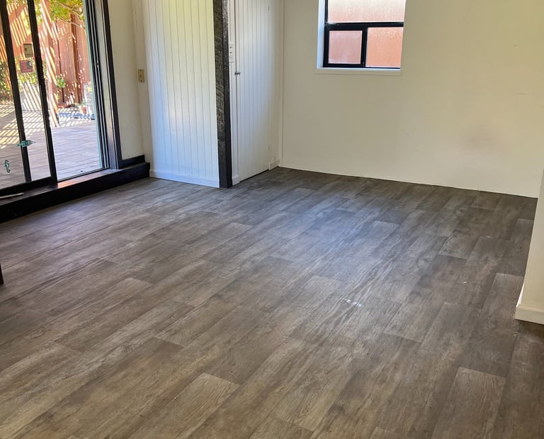 a living room with a large window and a sliding glass door