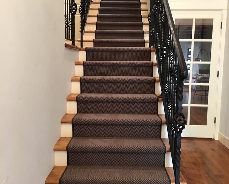 a staircase with a black and white carpet and a black stair case
