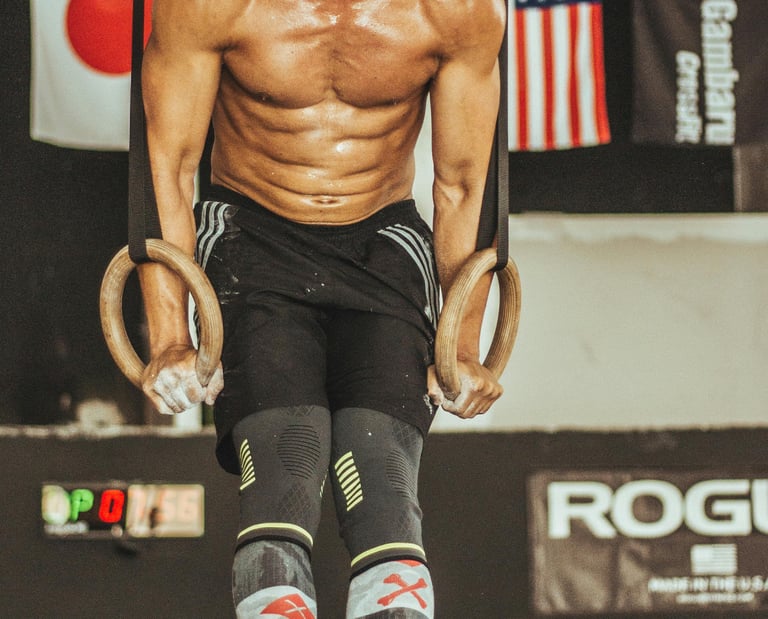 a man doing a pull up barbell in a gym