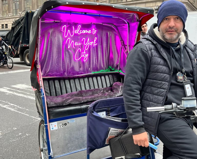 a man riding a bicycle with a purple cover