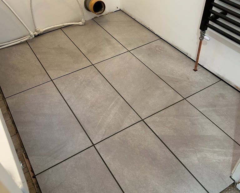 Toiler gone! Floor down, radiator in.