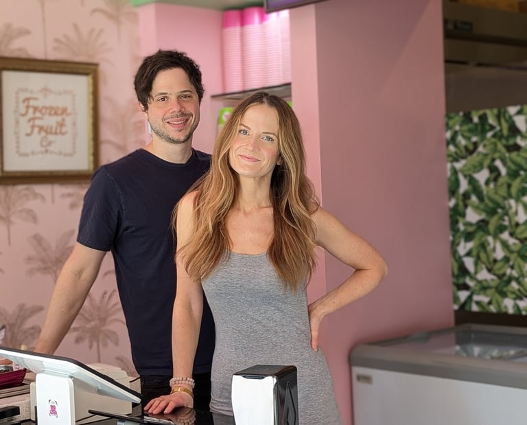 a man and woman standing in front of a counter