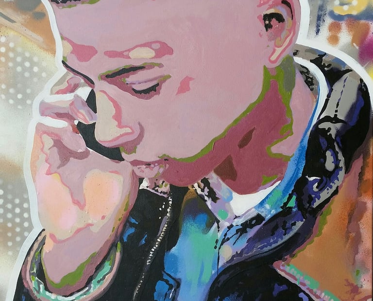 A colorful stencil art portrait of a young man on his phone with vibrant spray paint highlights.