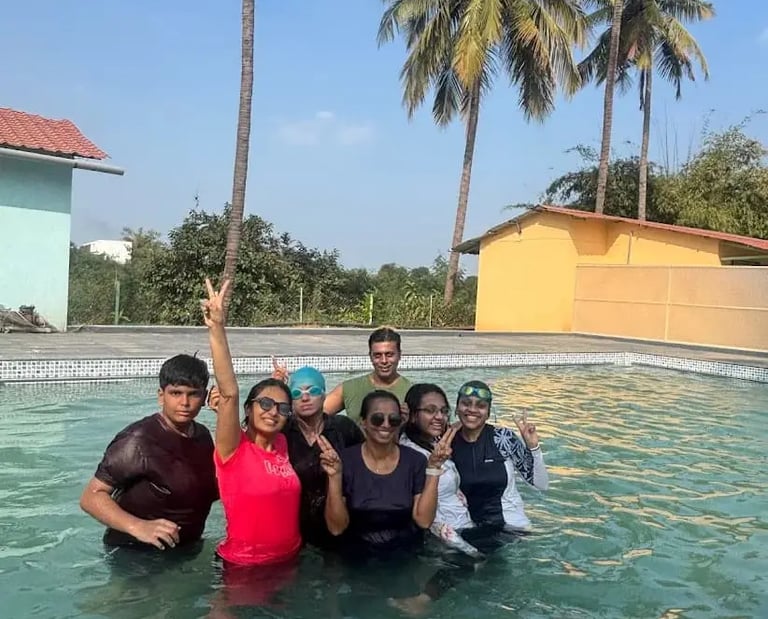 Family with kids enjoying swimming pool on one day picnic at purna river retreat