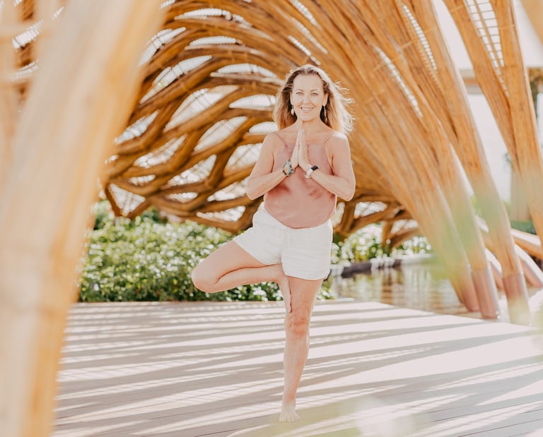 Erin B in a yoga pose at a retreat in Mexico