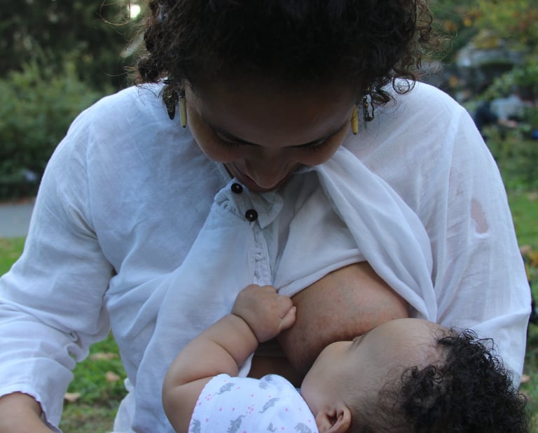 Iveth nursing her daughter