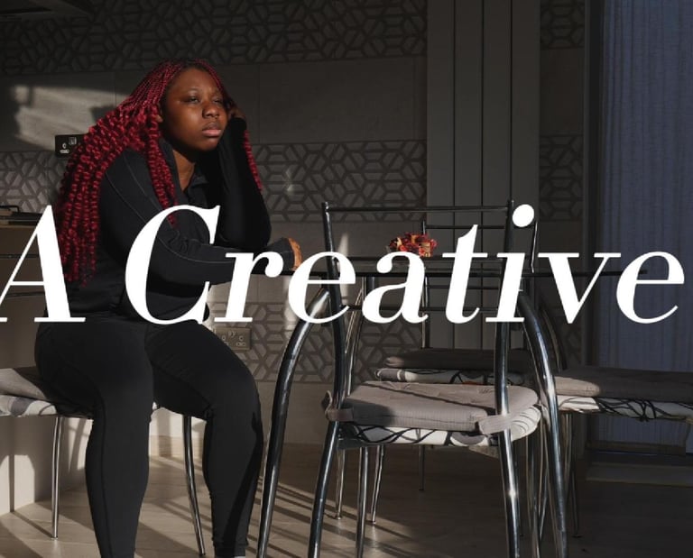 a picture of a girl with dark red hair sitting down in a video production