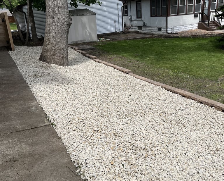 rock landscaping alongside residential driveway in buffalo mn