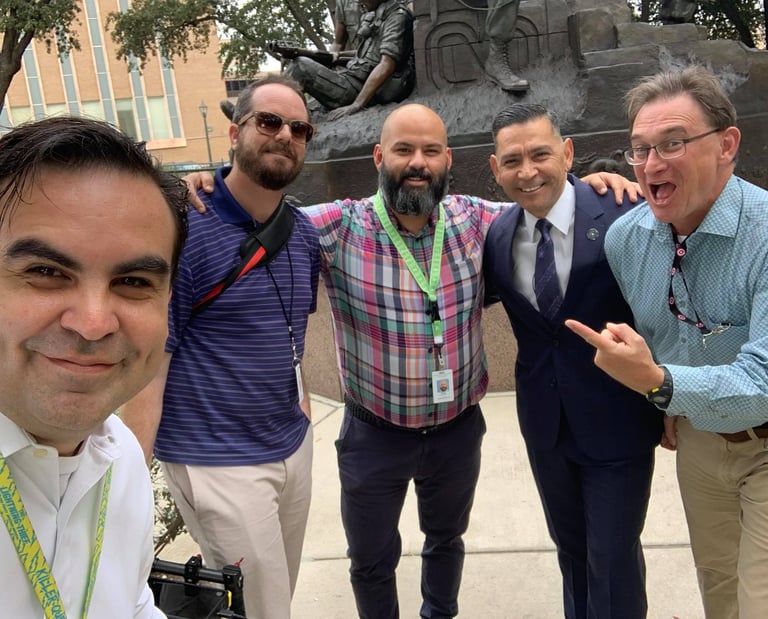 Francisco and communications team smile with Commissioner Julian Alvarez outside