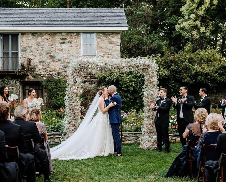 Couple kissing at alter in outdoor field
