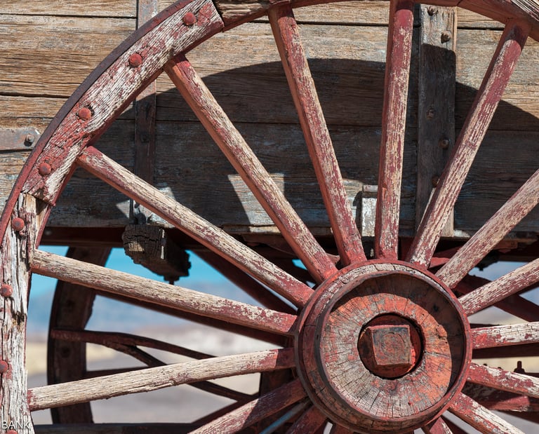 the red spokes of a wooden wagon wheel at harmony borax works in death valley