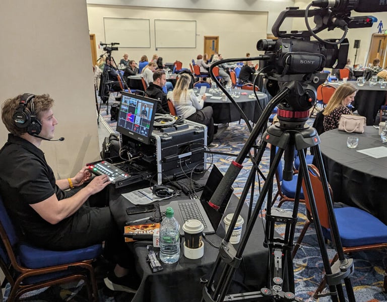 Videographer managing the event recording setup