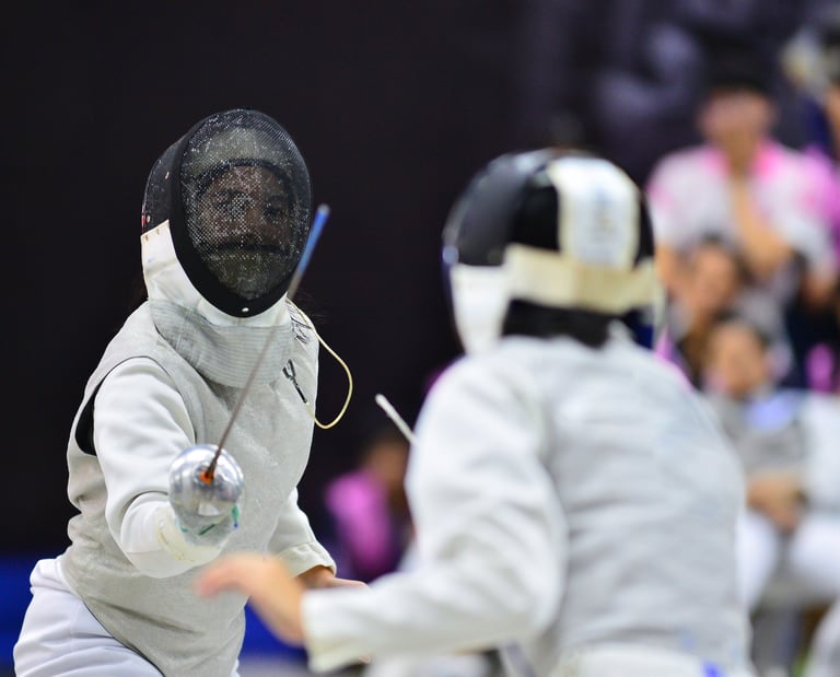a fenced in fenced in area with people watching