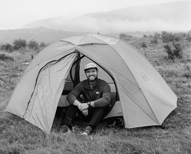 35mm film Nate Bowery sitting in tent while backpacking at Grayson Highlands State Park in Virgina
