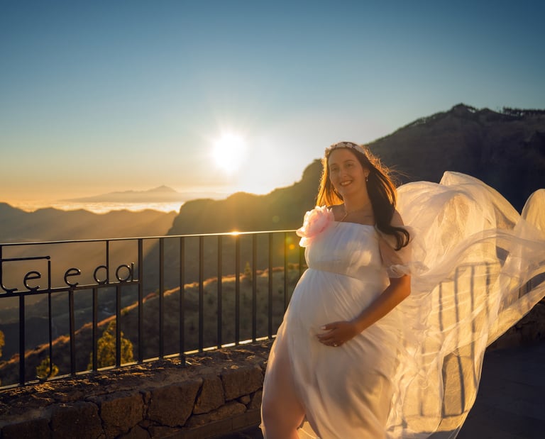 a pregnant woman in a white dress with a veil