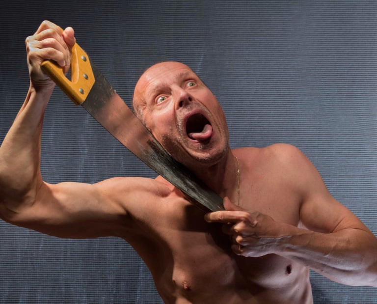 Male figure with an open mouth and a tongue out holding a handsaw blade against his neck. 
