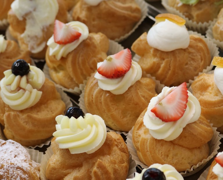 a variety of pastries on display in a bakery